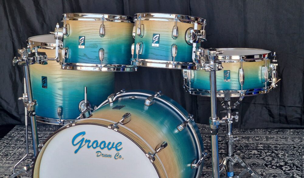Caribe Blue Fade to Natural Ash over Walnut Drums